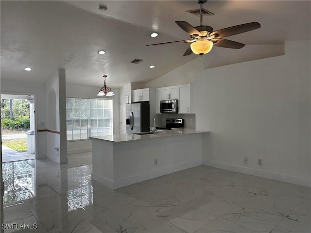 kitchen featuring kitchen peninsula, appliances with stainless steel finishes, decorative light fixtures, white cabinetry, and lofted ceiling