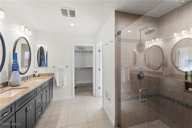 bathroom featuring tile patterned floors, vanity, and walk in shower