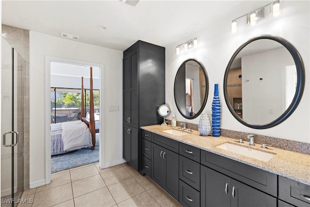 bathroom featuring vanity, tile patterned floors, and a shower with door