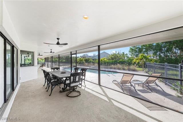 sunroom / solarium featuring ceiling fan