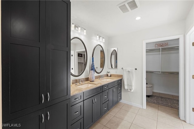 bathroom featuring tile patterned flooring and vanity