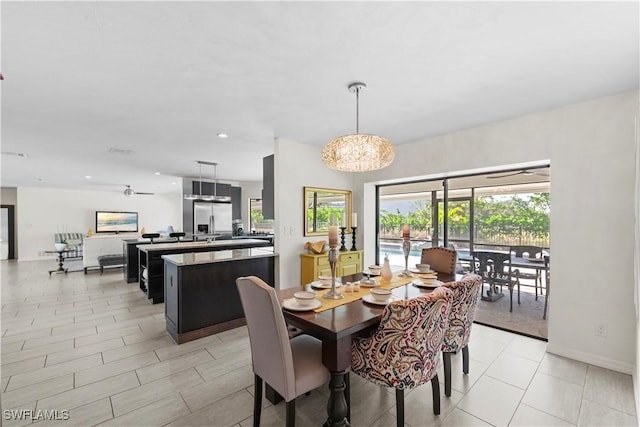 dining room featuring ceiling fan with notable chandelier