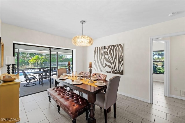 dining area featuring a healthy amount of sunlight and a notable chandelier