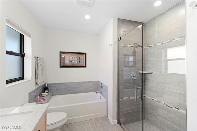 full bathroom with vanity, plus walk in shower, and toilet