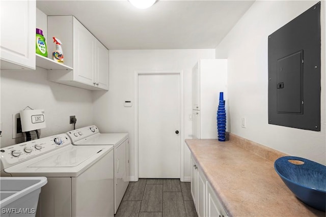 clothes washing area with electric panel, separate washer and dryer, sink, and cabinets