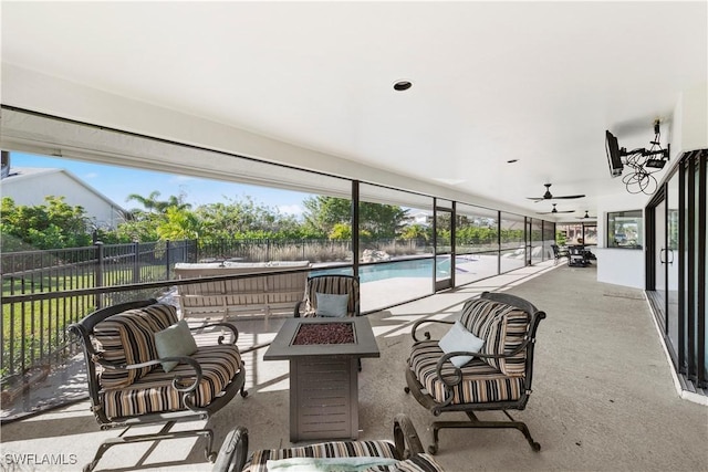 view of patio featuring a fenced in pool, a fire pit, and ceiling fan