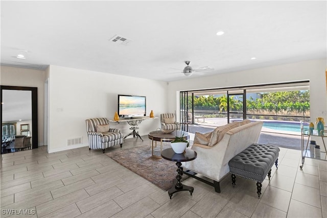 living room with ceiling fan and plenty of natural light