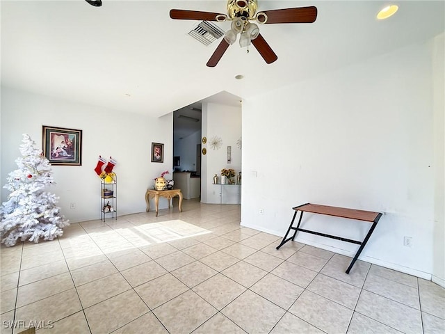 unfurnished room with ceiling fan and light tile patterned floors