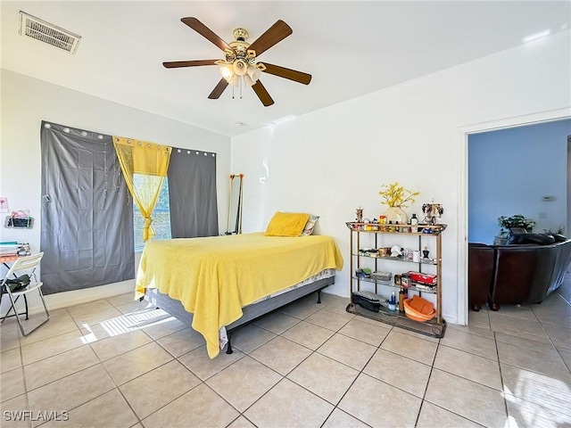 tiled bedroom with ceiling fan