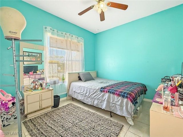 bedroom with ceiling fan and light tile patterned floors