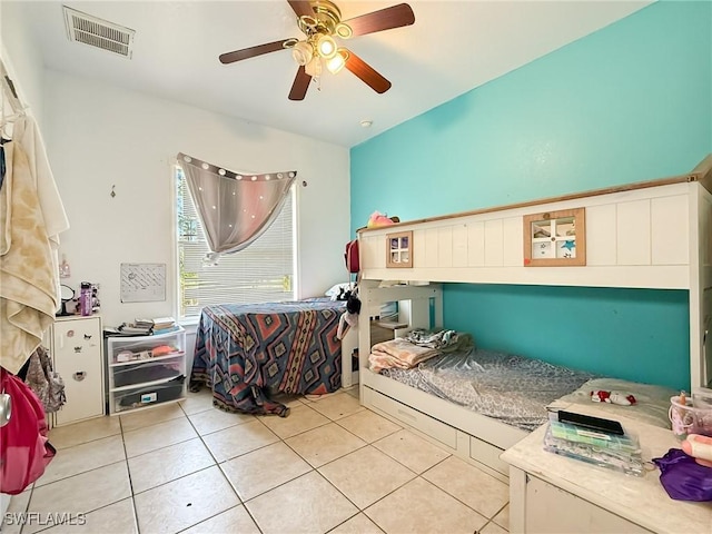 tiled bedroom featuring ceiling fan