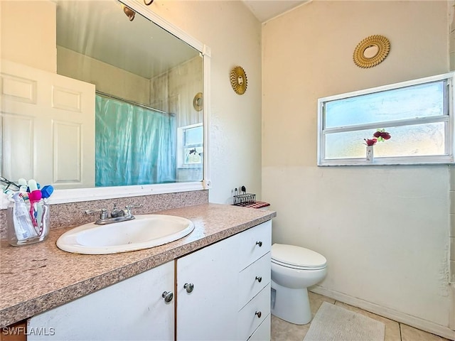 bathroom with tile patterned floors, walk in shower, vanity, and toilet