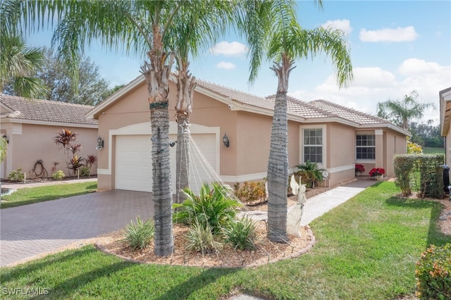 single story home with a garage and a front lawn