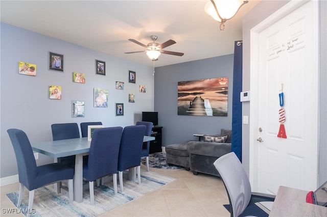 tiled dining area with ceiling fan