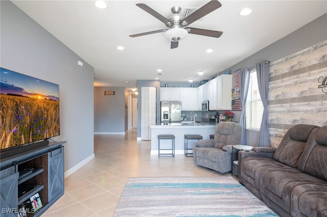 tiled living room featuring sink and ceiling fan