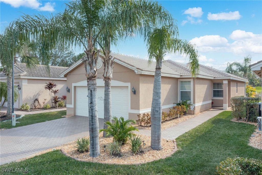 10498 Spruce Pine Ct, Fort Myers, FL 33913 - ranch-style house featuring a garage and a front lawn
