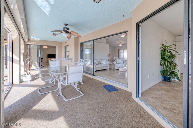 sunroom / solarium featuring ceiling fan