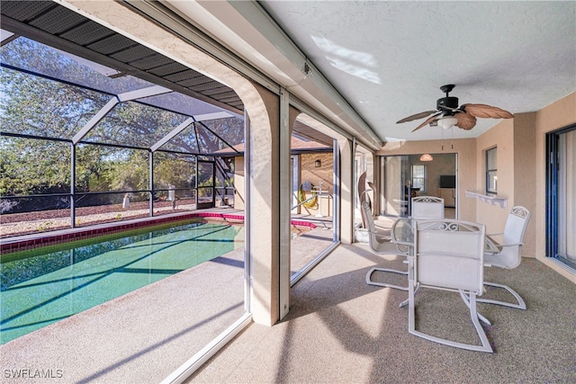 view of patio / terrace featuring ceiling fan and a lanai