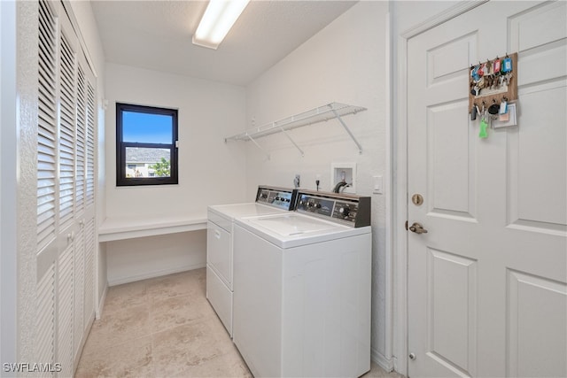 laundry area featuring washing machine and clothes dryer