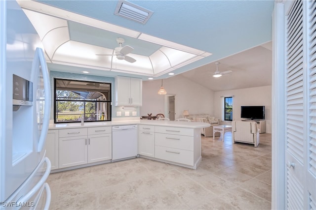 kitchen featuring white appliances, white cabinets, hanging light fixtures, ceiling fan, and kitchen peninsula