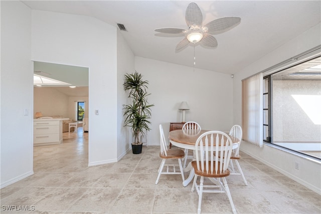 dining area featuring ceiling fan and vaulted ceiling