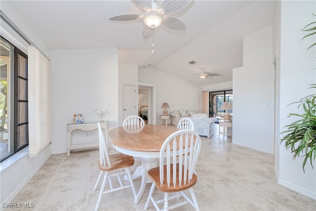 dining area with ceiling fan and lofted ceiling