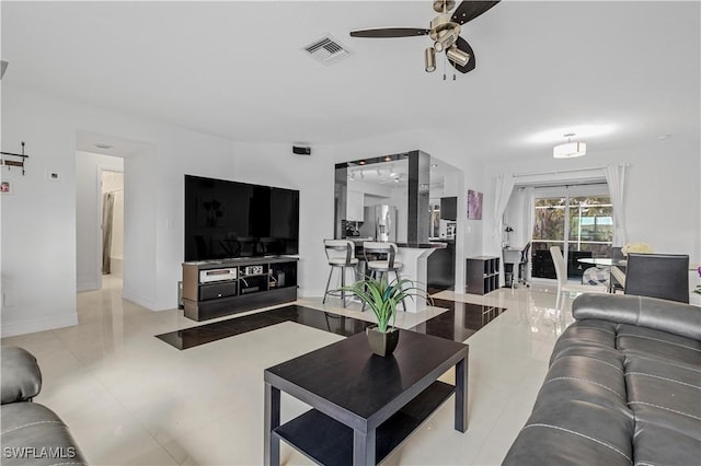 tiled living room featuring ceiling fan