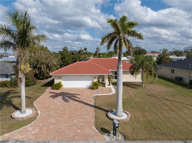 view of front of property featuring central AC, a front yard, and a garage