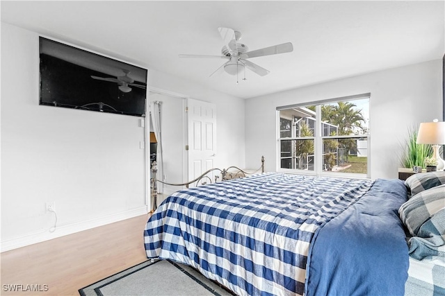 bedroom with ceiling fan and light hardwood / wood-style floors