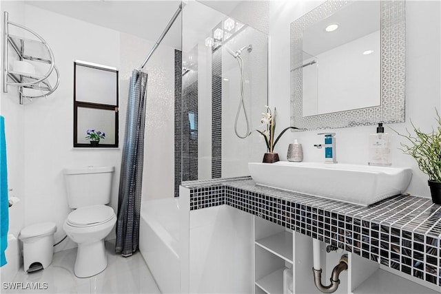 full bathroom with toilet, shower / bath combo with shower curtain, and sink