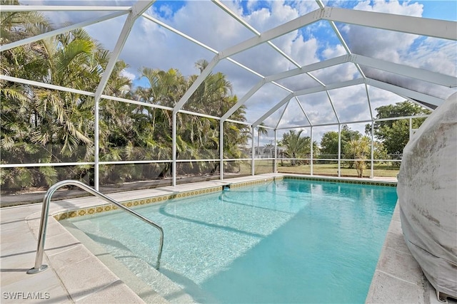 view of pool with glass enclosure