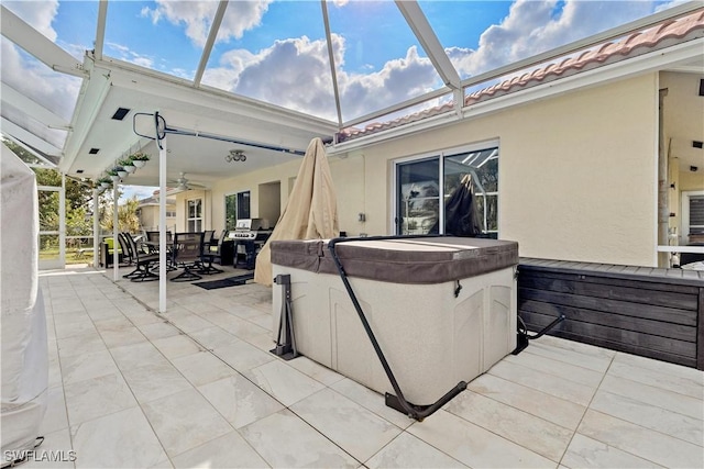 view of patio featuring ceiling fan and a hot tub