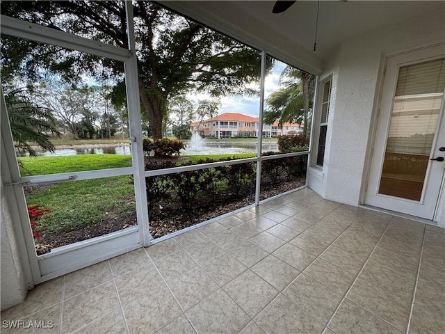 unfurnished sunroom with a water view and a wealth of natural light