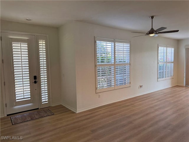 foyer entrance featuring ceiling fan and wood-type flooring