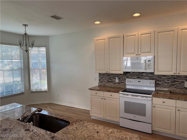 kitchen with white cabinetry and white appliances