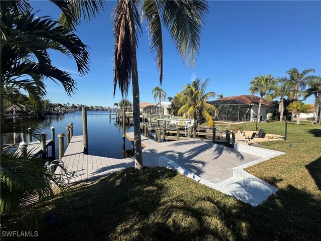 view of dock featuring a yard, a water view, and boat lift