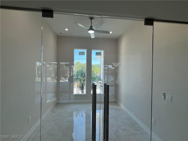 interior space featuring marble finish floor, ceiling fan, baseboards, and recessed lighting