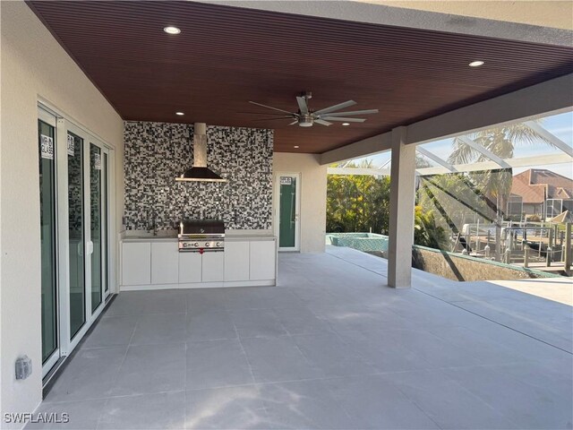 view of patio / terrace with ceiling fan, area for grilling, and glass enclosure