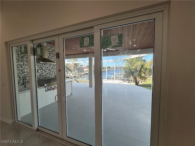 doorway to outside featuring tile patterned flooring and french doors