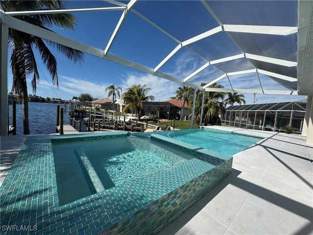 view of swimming pool featuring a patio, a water view, a boat dock, and a lanai