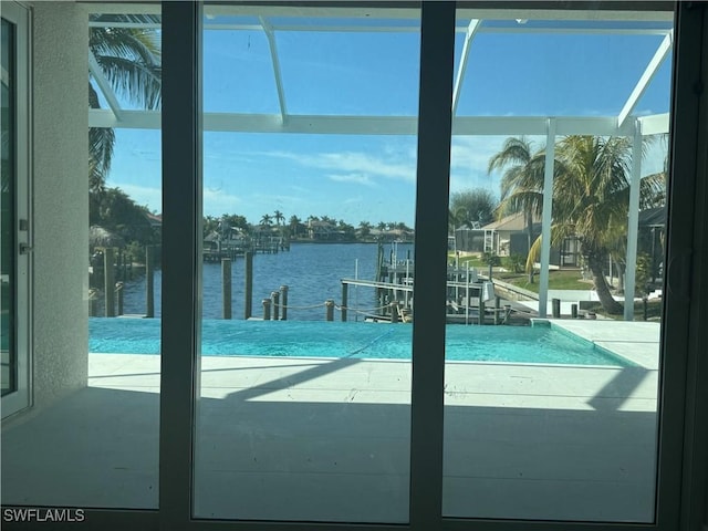 view of pool featuring a water view and a dock