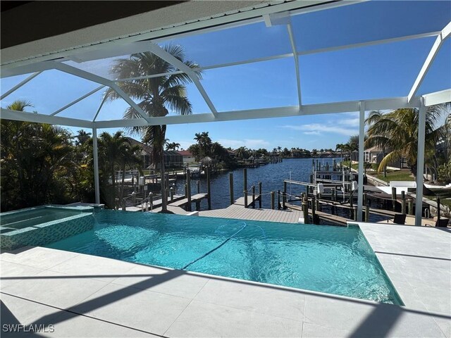 view of swimming pool featuring a patio, an in ground hot tub, glass enclosure, a water view, and a dock