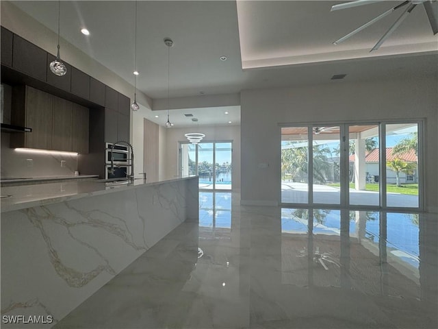 kitchen featuring visible vents, modern cabinets, hanging light fixtures, marble finish floor, and recessed lighting