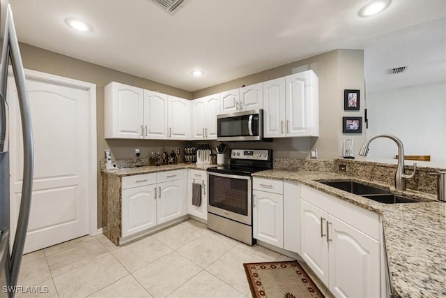 kitchen featuring white cabinets, appliances with stainless steel finishes, and sink