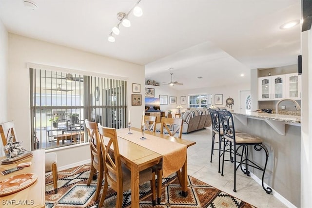 tiled dining area featuring ceiling fan