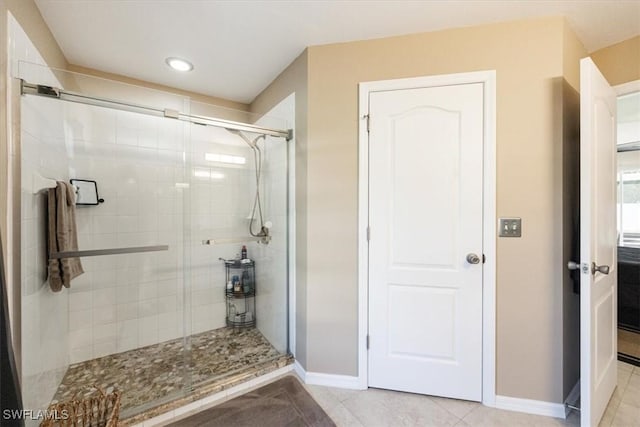 bathroom with tile patterned flooring and a shower with door