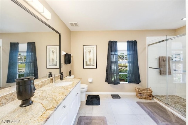 bathroom featuring tile patterned floors, vanity, an enclosed shower, and toilet