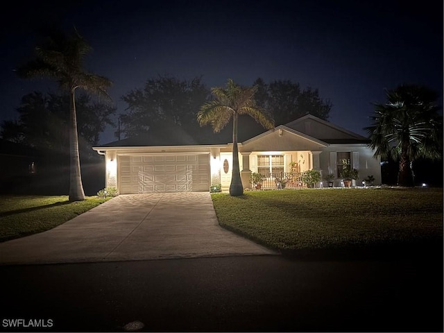 ranch-style home featuring a yard and a garage