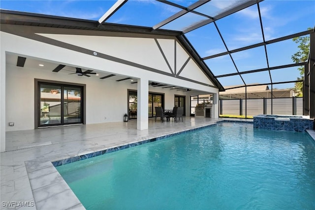 view of swimming pool featuring an in ground hot tub, ceiling fan, glass enclosure, and a patio area