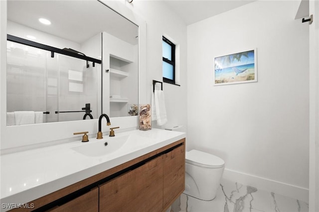 bathroom featuring vanity, toilet, and an enclosed shower